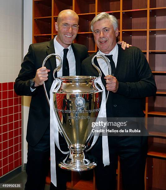 Carlo Ancelotti and Zinedine Zidane of Real Madrid lifts the Champions League trophy during the UEFA Champions League Final between Real Madrid and...