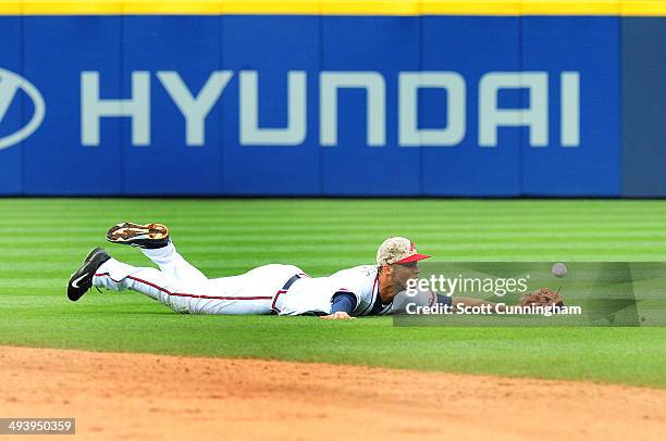 Andrelton Simmons of the Atlanta Braves is unable to reach a 7th inning run scoring single by A.J. Pierzynski of the Boston Red Sox at Turner Field...