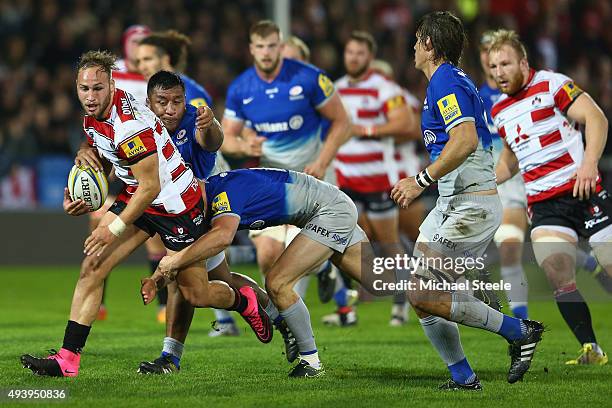 Bill Meakes of Gloucester is tackled by Chris Ashton and Mako Vunipola of Saracens during the Aviva Premiership match between Gloucester and Saracens...