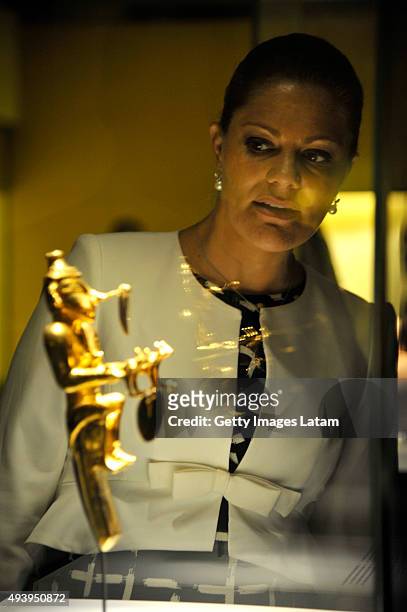 Crown Princess Victoria of Sweden looks at a prehispanic gold piece during a visit to the Gold Museum on October 23, 2015 in Bogota, Colombia.