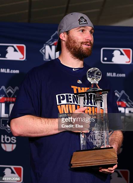 Daniel Murphy of the New York Mets poses with the NLCS MVP trophy after defeating the Chicago Cubs in game four of the 2015 MLB National League...