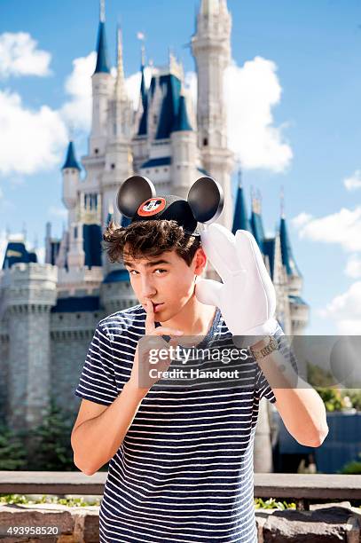 In this handout photo provided by Disney Parks, singer/songwriter Jacob Whitesides poses in front of Cinderella's Castle in the Magic Kingdom at Walt...