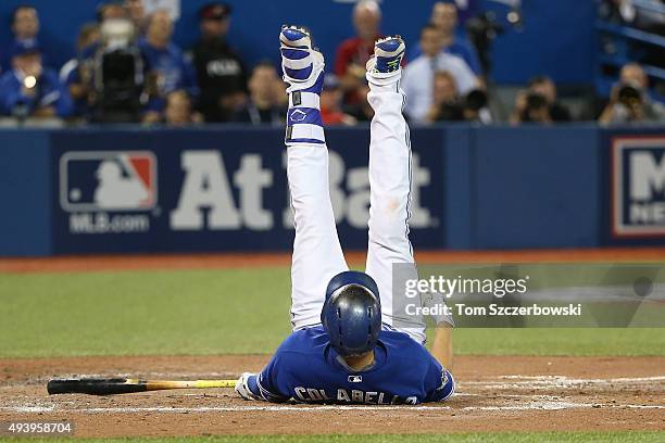 Chris Colabello of the Toronto Blue Jays falls after swinging in the third inning against the Texas Rangers during game five of the American League...