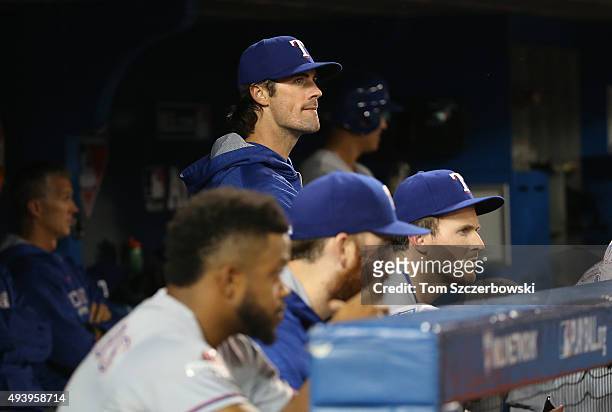 Cole Hamels of the Texas Rangers looks on from the dugout with his team facing elimination in the ninth inning against the Toronto Blue Jays during...