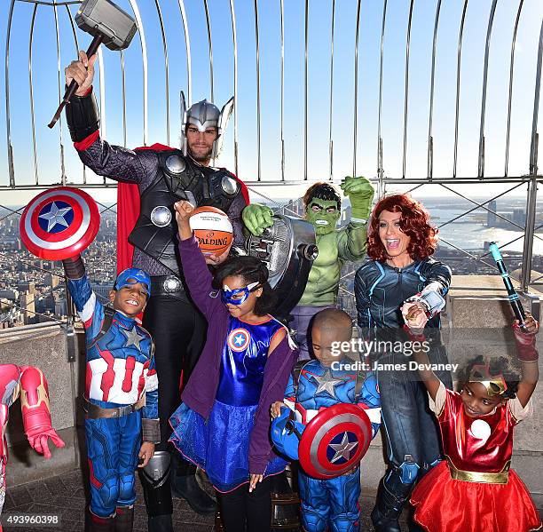 Robin Lopez, Jill Martin and children from the Garden of Dreams Foundation visit the Empire State Building on October 23, 2015 in New York City.