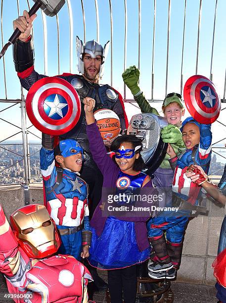 Robin Lopez and children from the Garden of Dreams Foundation visit the Empire State Building on October 23, 2015 in New York City.