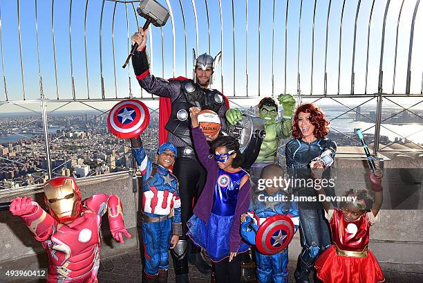 Robin Lopez, Jill Martin and children from the Garden of Dreams Foundation visit the Empire State Building on October 23, 2015 in New York City.