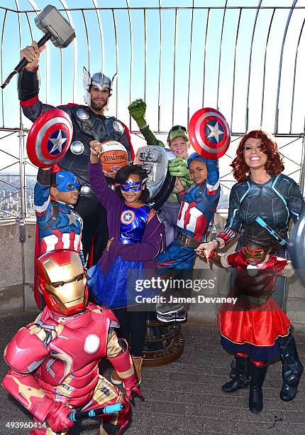 Robin Lopez, Jill Martin and children from the Garden of Dreams Foundation visit the Empire State Building on October 23, 2015 in New York City.