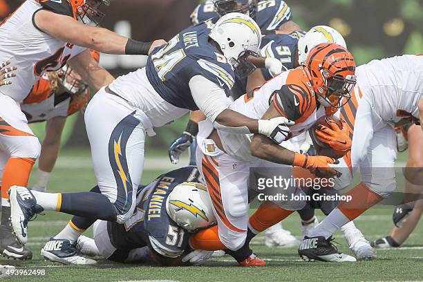 Jeremy Hill of the Cincinnati Bengals runs the football upfield against Corey Liuget of the San Diego Chargers during their game at Paul Brown...