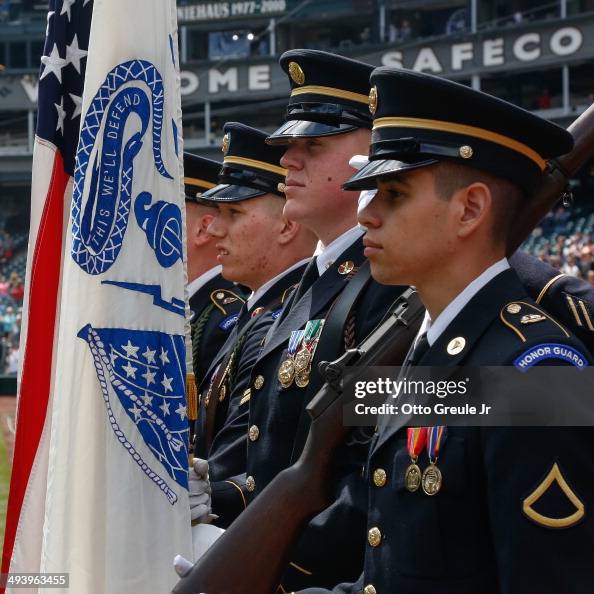 The color guard stands ready to present the flags prior to the game ...