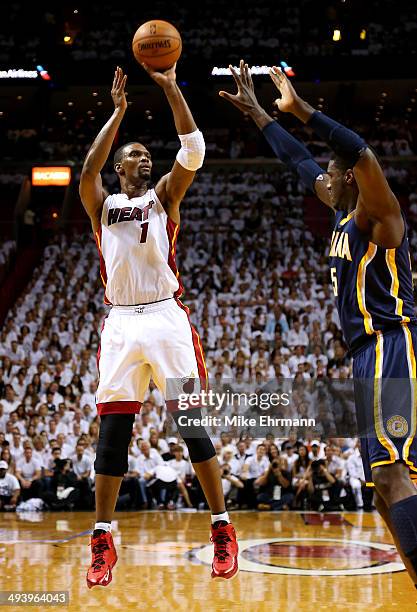 Chris Bosh of the Miami Heat takes a shot as Roy Hibbert of the Indiana Pacers defends during Game Four of the Eastern Conference Finals of the 2014...