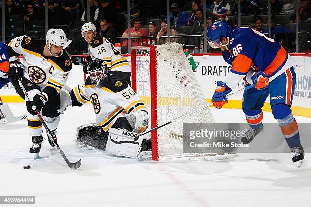 Jonas Gustavsson, Colin Miller, and Zdeno Chara of the Boston Bruins defend the net against Nikolay Kulemin of the New York Islanders at the Barclays...