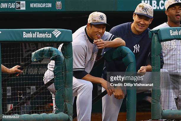 Pitchers Hiroki Kuroda and Masahiro Tanaka of the New York Yankees watch the game against the St. Louis Cardinals in the twelfth inning at Busch...