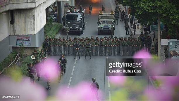 Thai army soldiers stand guard on a city centre street as an anti-coup rally is held nearby on May 26, 2014 in Bangkok, Thailand. Martial law has...