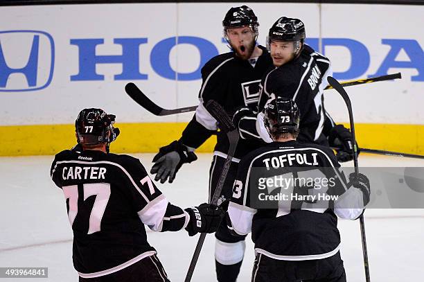 Jake Muzzin of the Los Angeles Kings and Dustin Brown celebrate Muzzin's first period goal against the Chicago Blackhawks in Game Four of the Western...