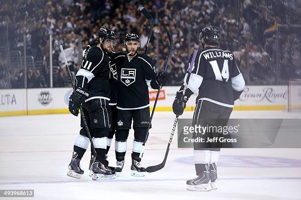 Drew Doughty of the Los Angeles Kings celebrates with teammates Alec Martinez, Anze Kopitar and Justin Williams after Doughty scores a second period...