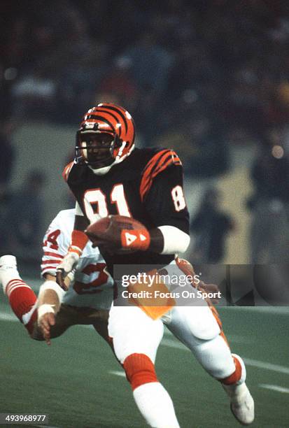 David Verser of the Cincinnati Bengals runs with the ball pursued by Rick Gervais of the San Francisco 49ers during Super Bowl XVI on January 24,...