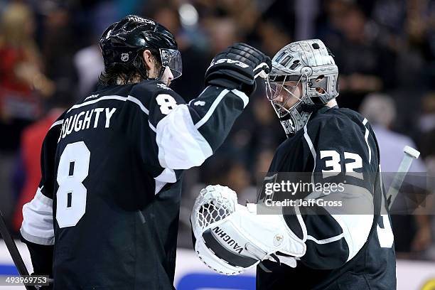 Drew Doughty and Jonathan Quick of the Los Angeles Kings celebrate after the Kings 5-2 victory against the Chicago Blackhawks in Game Four of the...