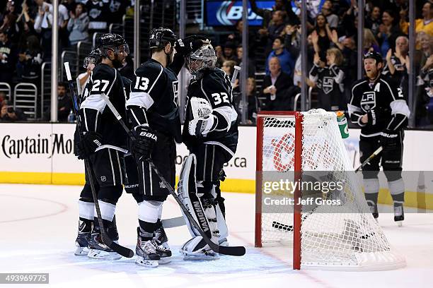 Kyle Clifford and Alec Martinez and Jonathan Quick of the Los Angeles Kings celebrate after the Kings 5-2 victory against the Chicago Blackhawks in...