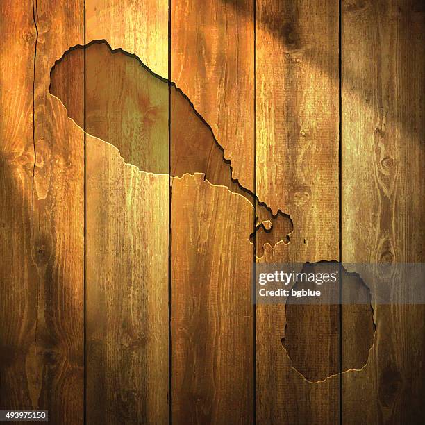 saint kitts and nevis map on lit wooden background - st kitts stock illustrations
