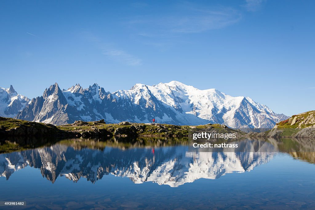 Runner in red runs in the French Alps near Chamonix