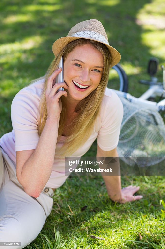 Smiling woman using mobile phone in park