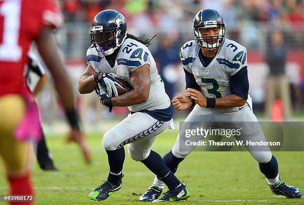 Marshawn Lynch of the Seattle Seahawks takes the handoff from Russell Wilson against the San Francisco 49ers during an NFL football game at Levi's...