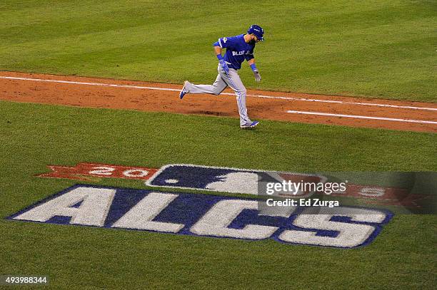 Jose Bautista of the Toronto Blue Jays rounds the bases after he hits a two-run home run in the eighth inning against the Kansas City Royals in game...