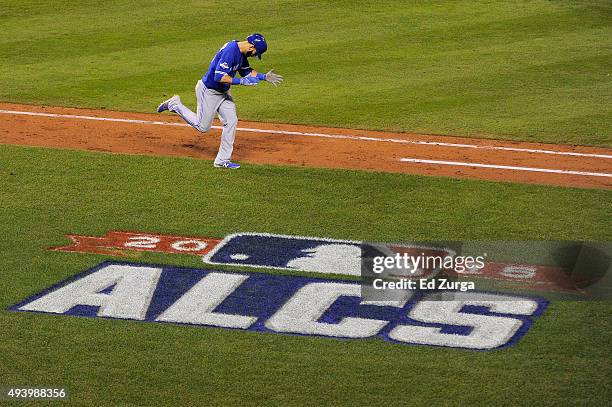 Jose Bautista of the Toronto Blue Jays rounds the bases after he hits a two-run home run in the eighth inning against the Kansas City Royals in game...