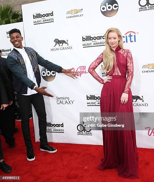 Professional Basketball player Nick Young of the Los Angeles Lakers jokes around with Iggy Azalea as they arrive at the 2014 Billboard Music Awards...