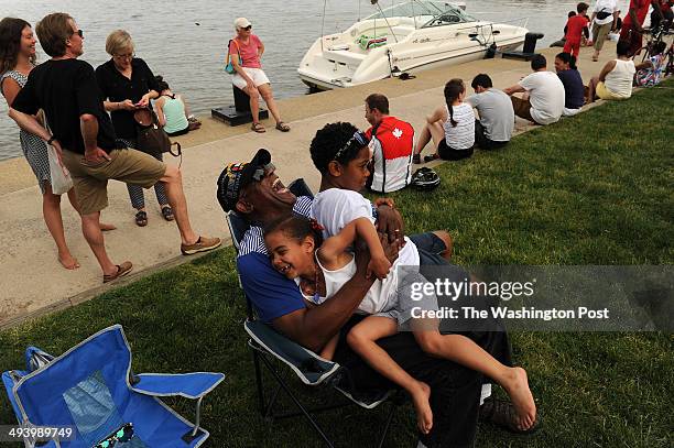 Bill Brown, bottom, laughs as he holds his granddaughter, Caelyn Jimenez and grandson, Dominique Jimenez during the annual Memorial Day Jazz Festival...