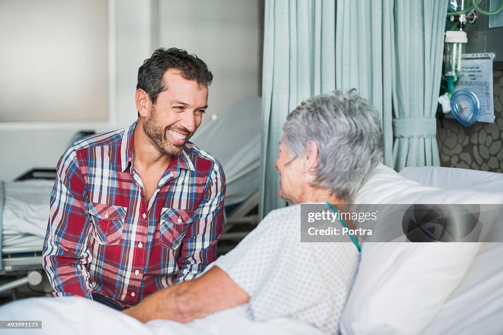 Son visiting his mother in hospital