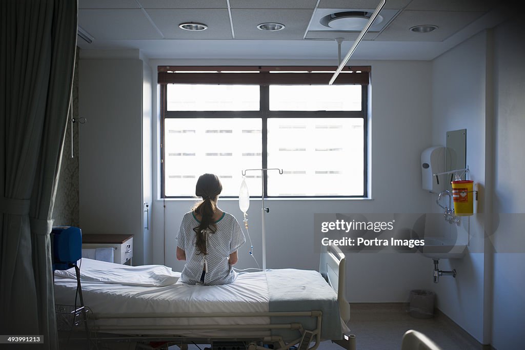 Patient sitting on hospital bed waiting