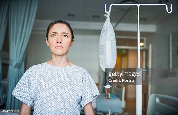 patient sitting in a recovery room with iv fluids - patient room stockfoto's en -beelden