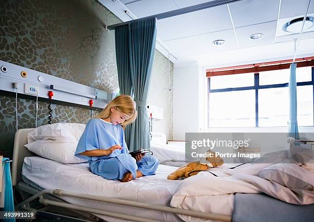 girl recovering in a hospital - girl in hospital bed sick stock pictures, royalty-free photos & images