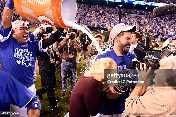 Salvador Perez dumps water on Eric Hosmer of the Kansas City Royals after winning Game 6 of the ALCS against the Toronto Blue Jays at Kauffman...