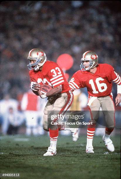 Joe Montana of the San Francisco 49ers hands the ball off to running back Roger Craig against the Miami Dolphins during Super Bowl XIX on January 20,...