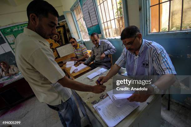 An Egyptian man prepares to cast his ballot at a polling station on the second day of the Egyptian presidential election in Alexandria, Egypt on May...
