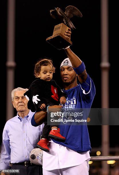 Alcides Escobar of the Kansas City Royals celebrates with the Lee MacPhail Most Valuable Player Award with son Massimiliano Escobar after the Royals...