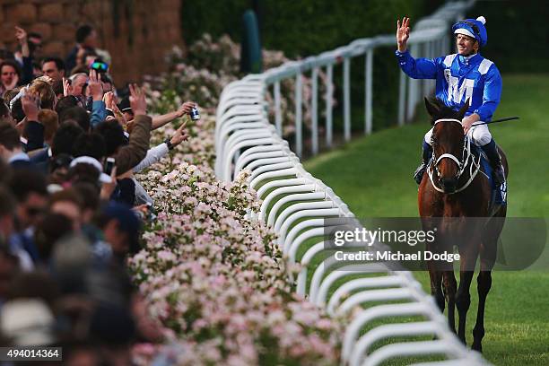 Hugh Bowman riding Winx celebrates with the crowd after winning race 9 The William Hill Cox plate during Cox Plate Day at Moonee Valley Racecourse on...