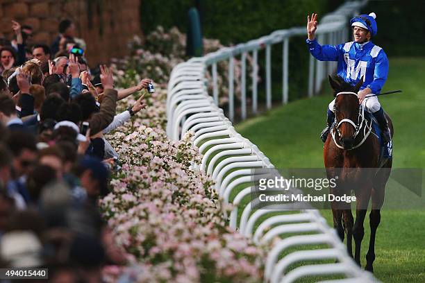 Hugh Bowman riding Winx celebrates with the crowd after winning race 9 The William Hill Cox plate during Cox Plate Day at Moonee Valley Racecourse on...