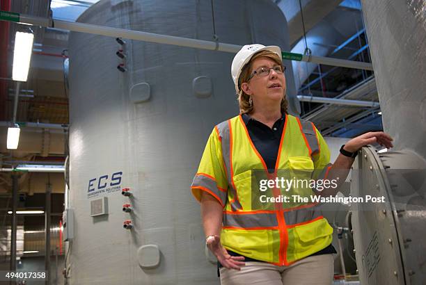 Alexandria Renew Enterprises CEO and GM Karen Pallansch with one of several carbon odor filter tanks that ensures that no foul odors will escape from...