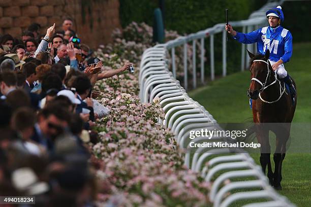 Hugh Bowman riding Winx celebrates with the crowd after winning race 9 The William Hill Cox plate during Cox Plate Day at Moonee Valley Racecourse on...