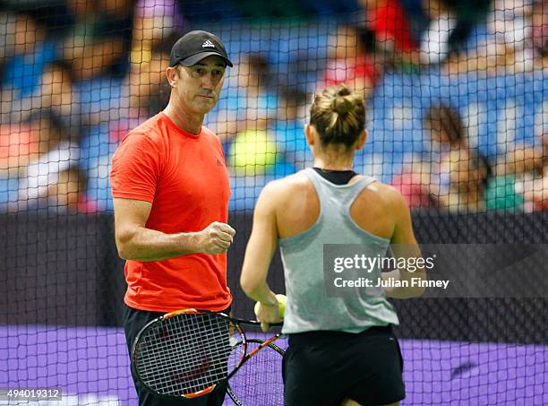 Simona Halep of Romania practices with her coach Darren Cahill prior to the BNP Paribas WTA Finals at OCBC Arena on October 24, 2015 in Singapore.