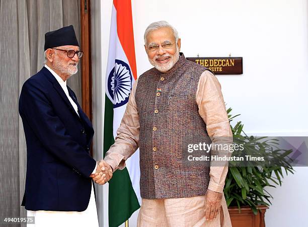 Indian Prime Minister Narendra Modi shakes hands with Prime Minister of Nepal Sushil Koirala during a meeting, at Hyderabad House on May 27, 2014 in...