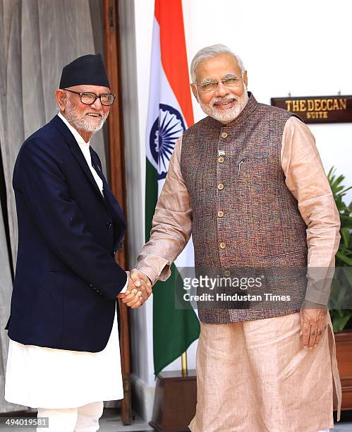 Indian Prime Minister Narendra Modi shakes hands with Prime Minister of Nepal Sushil Koirala during a meeting, at Hyderabad House on May 27, 2014 in...