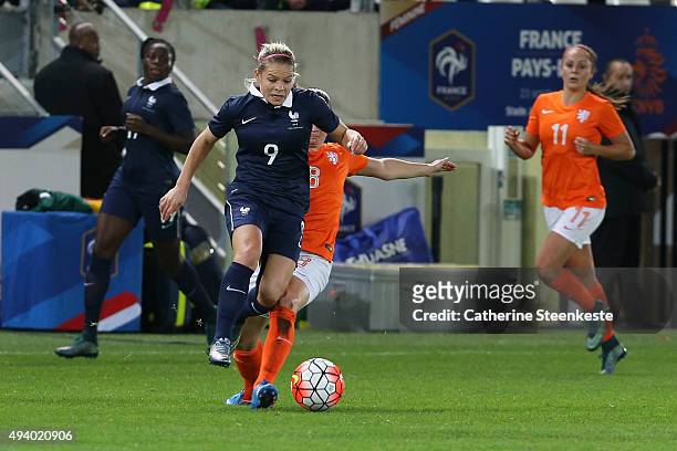 Eugenie Le Sommer of France competes for the ball against Sherida Spitse of Netherlands during the international friendly game between France and...