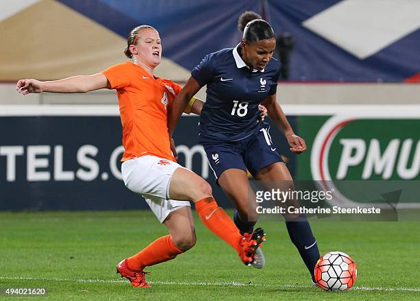 Marie-Laure Delie of France controls the ball against Mandy van den Berg of Netherlands during the international friendly game between France and...