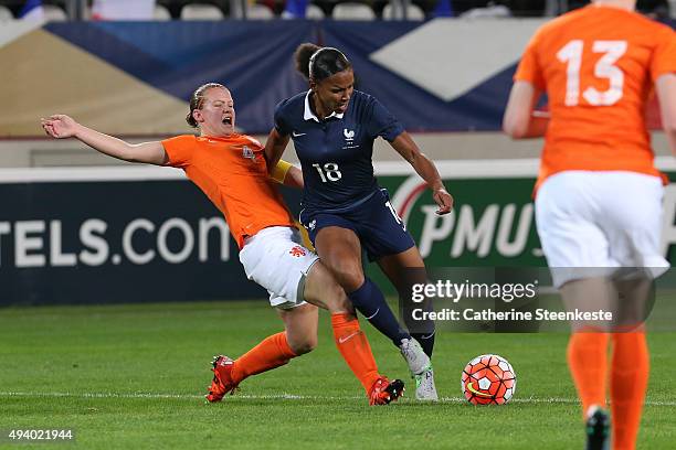 Marie-Laure Delie of France tries to control the ball against Mandy van den Berg of Netherlands during the international friendly game between France...