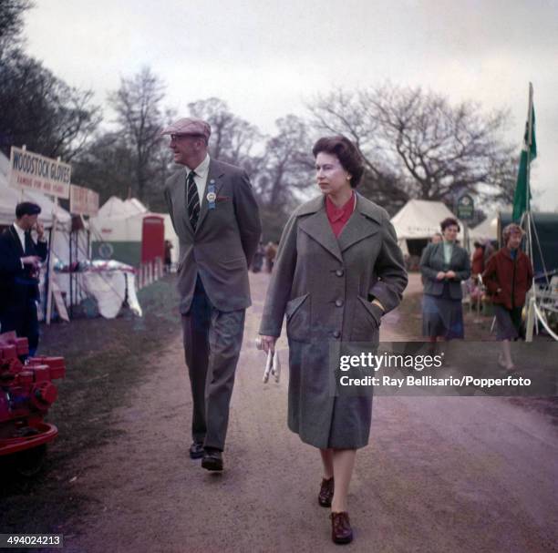 Queen Elizabeth II having a look around the stalls with the Duke of Beaufort during the Badminton Horse Trials in Gloucestershire on 21st April 1960.